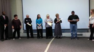 Division B Humorous Speech Contestants (l to r): Kory May, Meg Schneider, Anthony Moschetti, Sherry Sullivan, Michele Ortega, Marilyn McConkey Boyles, and Wilbert Merrick Mitchell. Theresa Mickelson, Division B Director listens as Wilbert responds to her contestant interview question.