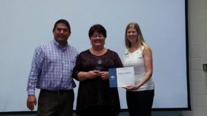 Meg Schneider being presented First Place by District Director Keith Nielsen and Division B Director Theresa Mickelson for the Humorous Speech Contest for her speech "What Would Han Solo Do?".